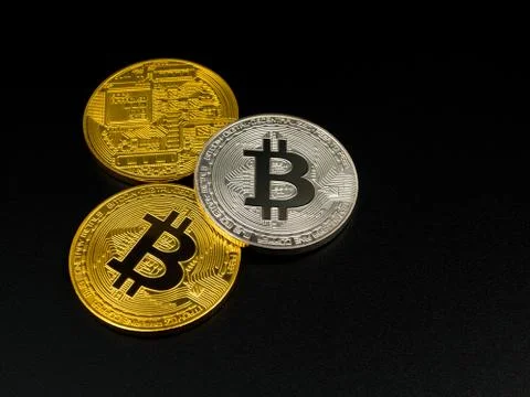 Golden and silver bitcoin on black background. Bitcoin cryptocurrency. Stock Photos