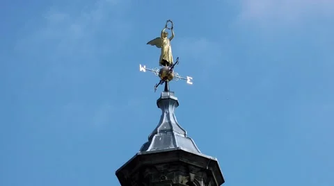 Golden angel wethervane weather vane nesw blue sky Stock Footage 49008666
