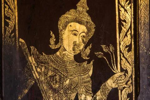 Golden antique drawing of Thai guarden angels on temple door Stock Photos