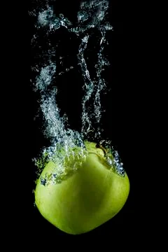 Golden apple splasing. Stock Photos