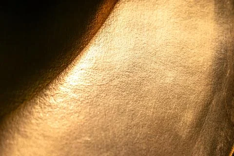 Golden background of an authentic image of an object, zoom on its texture f.. 스톡 사진