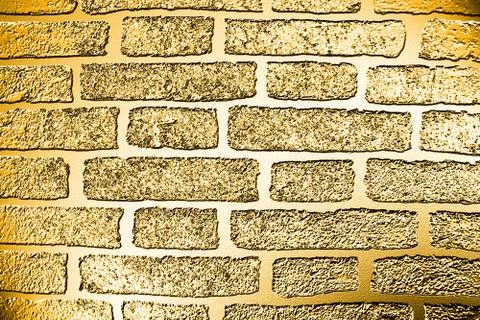 Golden background based on the image of a brick wall tinted in gold Stock Illustration