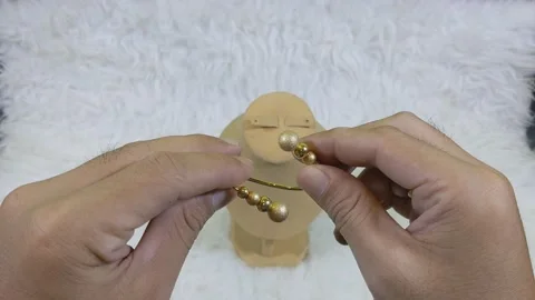 Golden bangle bracelets are used for store displays and jewelry companies Stock Footage 237568611
