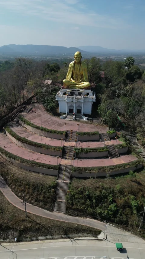 Golden Big Monk Statue Overlooking Lamphun, Thailand Landscape Stock Footage 335601635