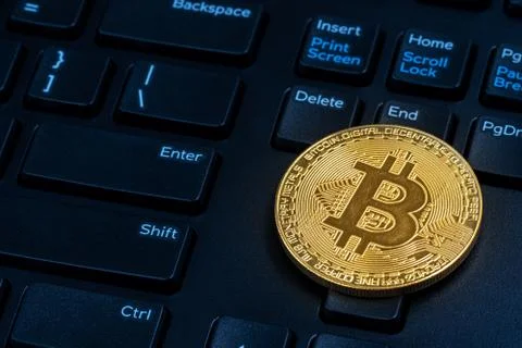 Golden bitcoin and computer Stock Photos