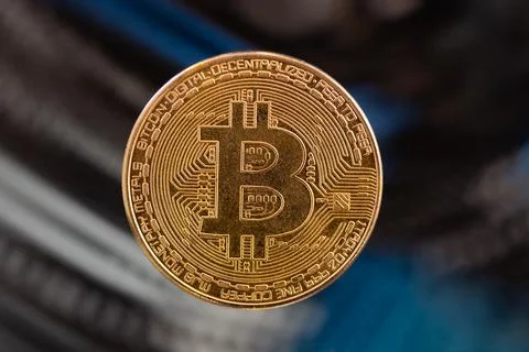 The golden bitcoin, on a background a part of computer Stock Photos