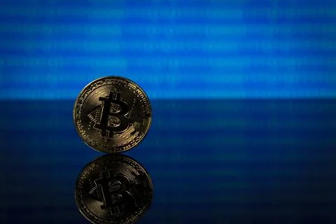 Golden bitcoin, binary code on a blue background 스톡 사진