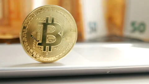 Golden bitcoin BTC fluttering on the background of a 50 euro currency Stock Footage 88716252