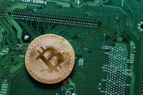 Golden Bitcoin on Computer Microcircuit Top View Stock Photos