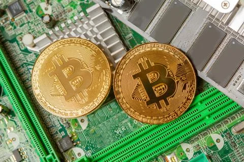 Golden Bitcoin Cryptocurrency on computer circuit board. Macro shot Stock Illustration