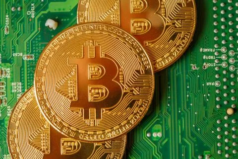 Golden Bitcoin Cryptocurrency on computer circuit board. Macro shot Stock Illustration