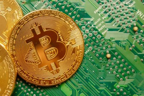 Golden Bitcoin Cryptocurrency on computer circuit board. Macro shot Stock Illustration