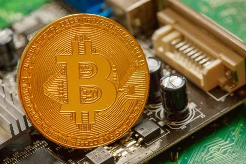 Golden Bitcoin Cryptocurrency on computer circuit board. Macro shot Stock Illustration