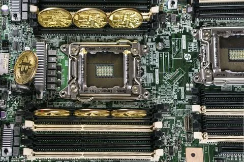 Golden Bitcoin Cryptocurrency on computer circuit board. Blockchain and security Stock Photos