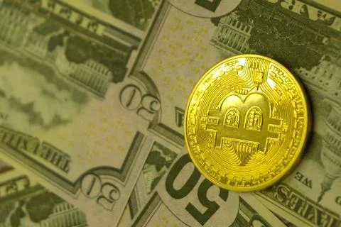A golden bitcoin on dollar graph background. Financial Electronic Technology  Stock Photos