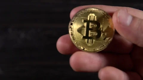 Golden bitcoin in the hands Stock Footage 87211594