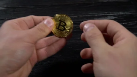 Golden bitcoin in the hands Stock Footage 87218403