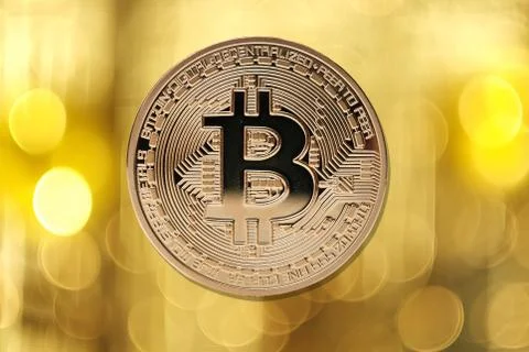 Golden bitcoin isolated on blurred light background Stock Photos