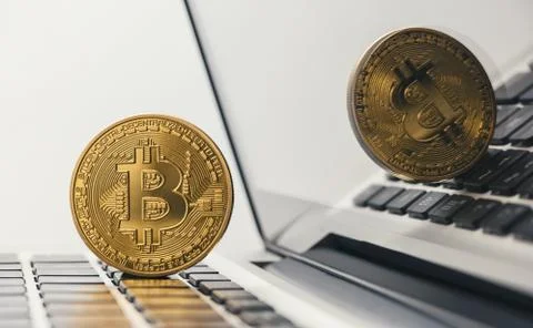 Golden bitcoin on notebook 写真素材