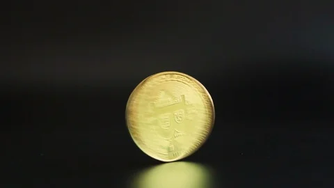 Golden Bitcoin is spinning until it stops and falls. Stock Footage 87183078