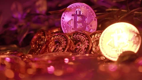 Golden Bitcoin stack reflecting light, symbolizing cryptocurrency. BTC Stock Footage 287304469