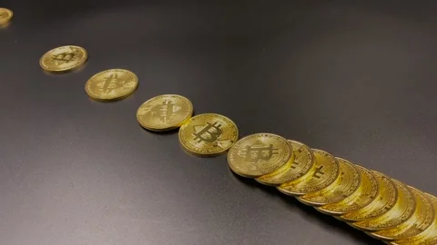 Golden bitcoins fall in line Stock Footage 147306920