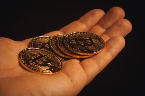 Golden bitcoins on a hand Stock Photos