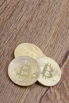 Golden Bitcoins on a table Stock-Fotos