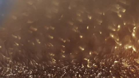 Golden bokeh background with a shifting focus, ideal for festive holiday scenes. Stock Footage 292687119