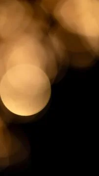 Golden bokeh light circles creating a warm, soft, and abstract background, .. Stock Photos