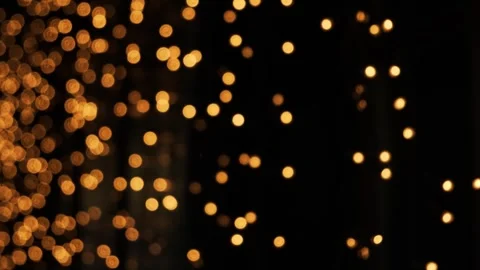 Golden bokeh light particles floating in dark space. Abstract glowing dots motio Видео 340450352