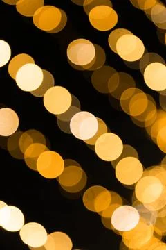 Golden Bokeh Light Pattern on a Dark Background Stock Photos