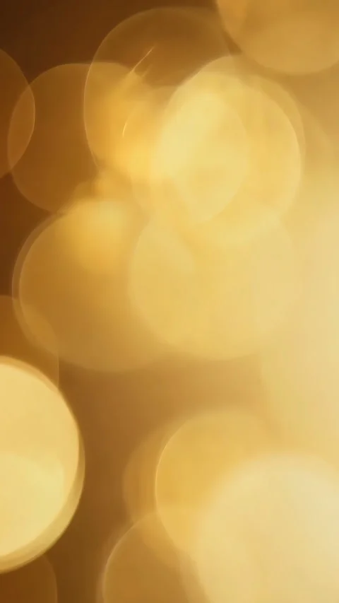 Golden bokeh lights background changing and shimmering. Vertical video. Stock Footage 310390041