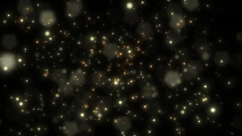 Golden bokeh lights on black background. Abstract glowing particles floating in Vídeos de archivo 339646393