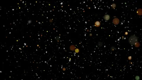 Golden bokeh particles on black background. Floating dust lights for festive Видео 339646391