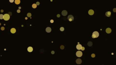 Golden bokeh particles floating against a deep solid black background texture 库存影片 335149787