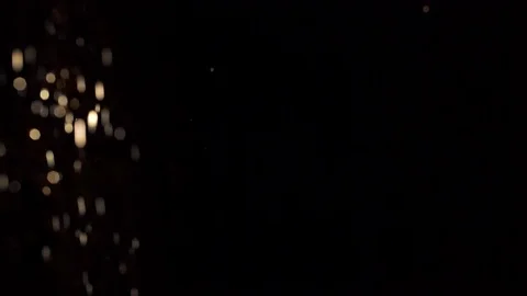 Golden bokeh randomly moving on black background Stock-Footage 120726344