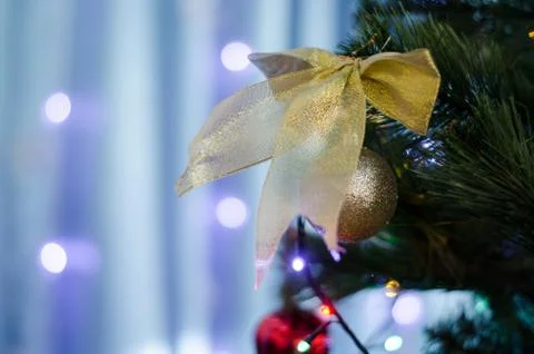 Golden bow and balls on the tree. Stock Photos