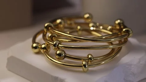 Golden bracelet displayed on a clean surface Stock Footage 337250889