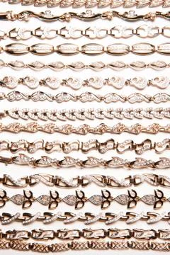 Golden bracelets on a studio background Stock-Fotos
