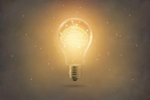 Golden brain glowing inside light bulb on paper texture background Stock Photos