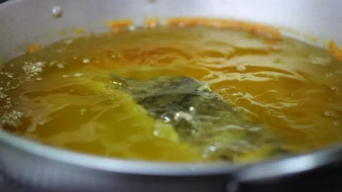 Golden Broth Simmering in a Large Kitchen Pot Stock Footage 341679107