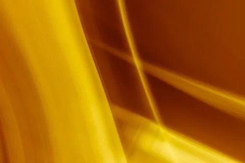 Golden brown abstract background from the intersection of rays. Stock Photos