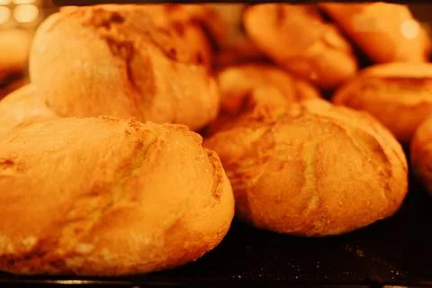 Golden brown bread rolls just baked, glowing with warmth and texture. Perfect Stock Photos