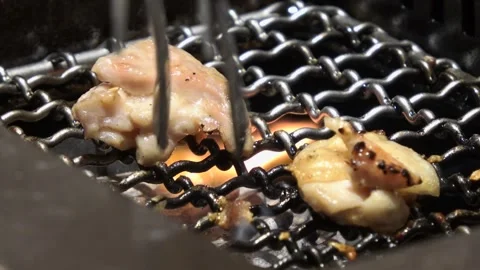 Golden-brown chicken pieces crackle deliciously on the barbecue. Stock Footage 313493053