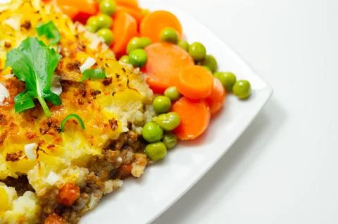 Golden brown dish with mashed potatoes and savory filling Stock Photos