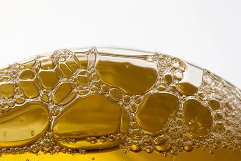 Golden Bubbles. Close-up of transparent bubbles in golden liquid Stock Photos