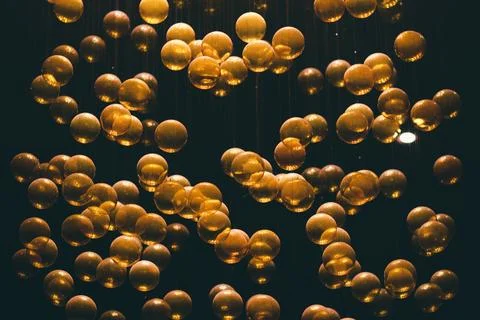 Golden bubbles floating in dark liquid Stock Photos