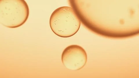 Golden bubbles with micro particles on warm background. イラスト素材