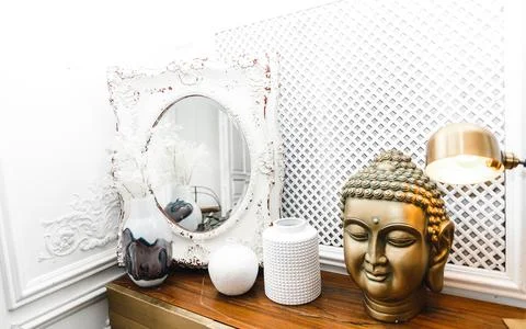 A golden Buddha head on a table. Stock Photos